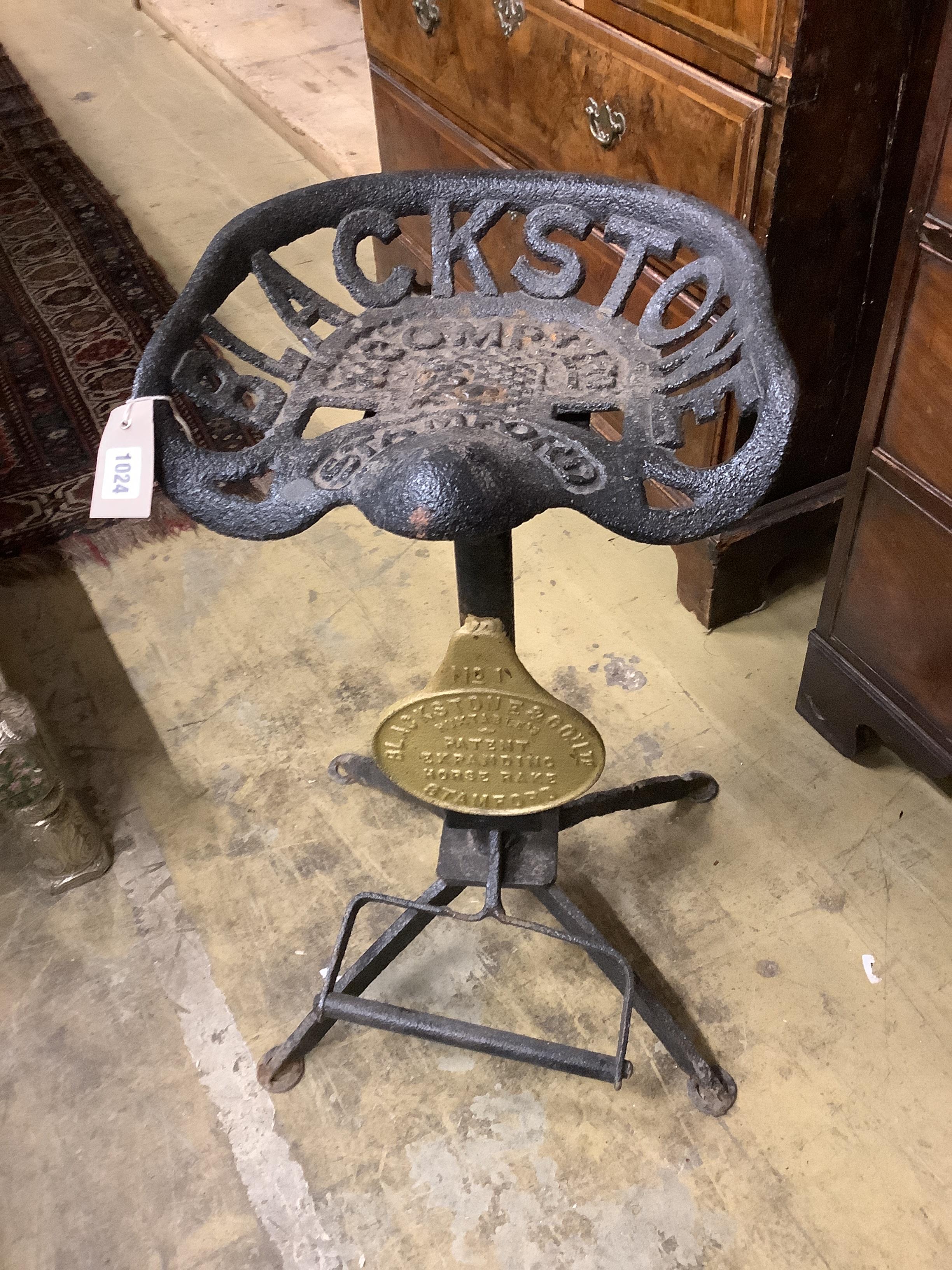 A cast iron tractor seat stool, height 70cm